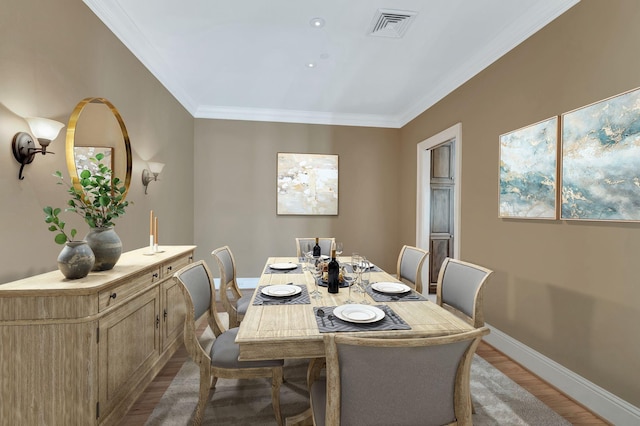 dining room featuring wood finished floors, visible vents, baseboards, and ornamental molding