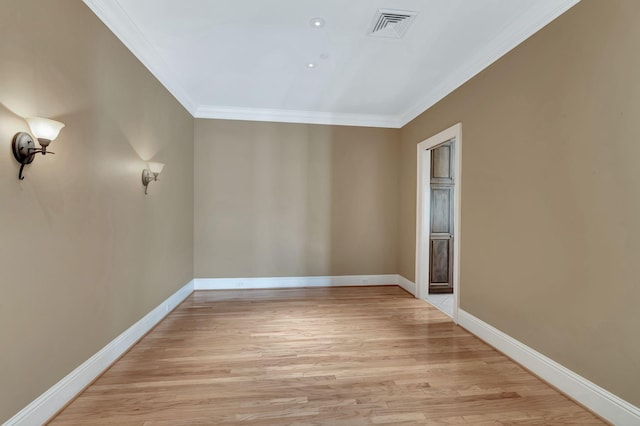 unfurnished room with visible vents, baseboards, crown molding, and light wood-style floors