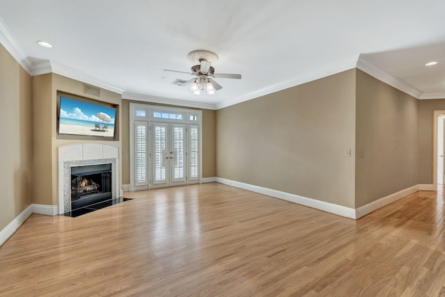 unfurnished living room featuring a fireplace, light wood-style floors, baseboards, and ornamental molding