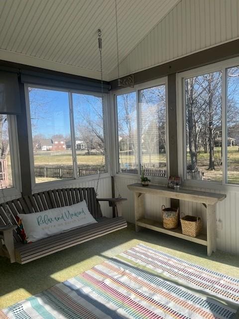 sunroom featuring a wealth of natural light and vaulted ceiling