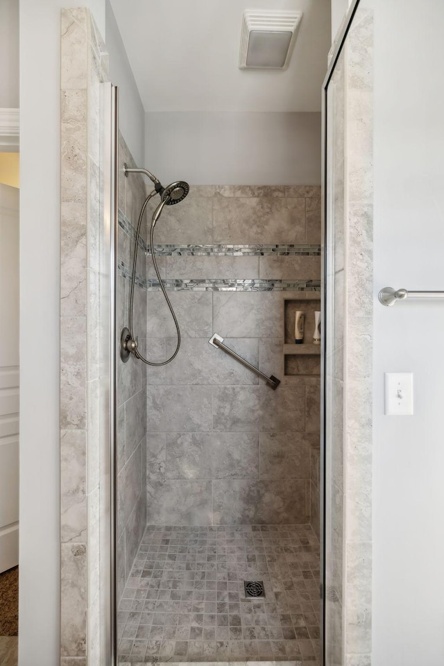 bathroom featuring visible vents and a stall shower