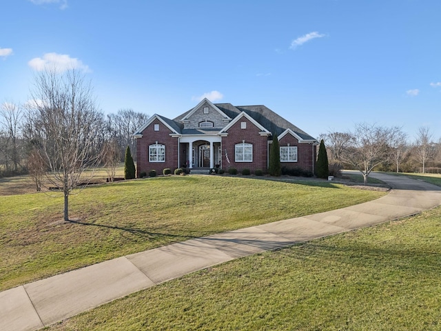 traditional-style house with a front yard and brick siding