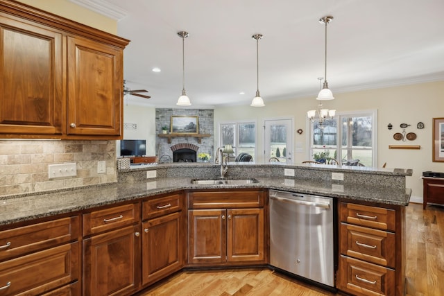 kitchen featuring a sink, plenty of natural light, dishwasher, and crown molding