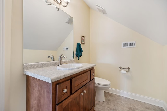 bathroom with visible vents, vanity, and vaulted ceiling