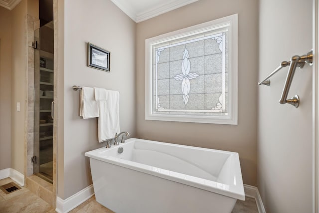 full bathroom with a shower stall, crown molding, baseboards, and a freestanding tub