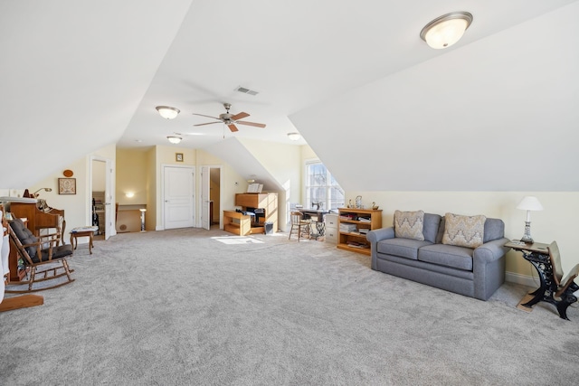 carpeted living room featuring visible vents, a ceiling fan, and vaulted ceiling