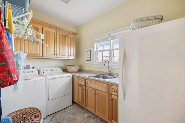 laundry area with a sink, cabinet space, and washer and dryer