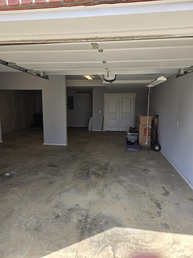 garage with electric panel and a garage door opener