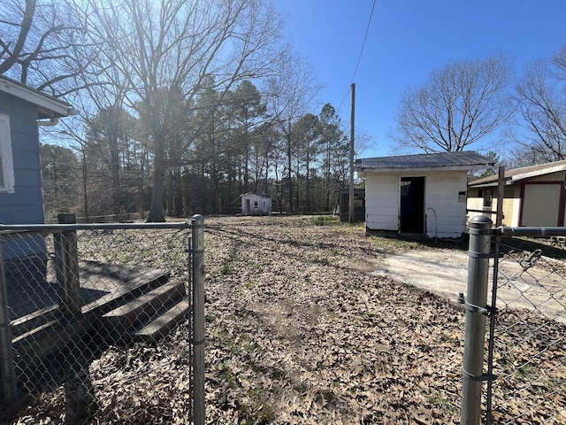 view of yard with an outdoor structure, a storage unit, and fence