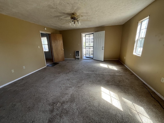 unfurnished living room with baseboards, a textured ceiling, and carpet