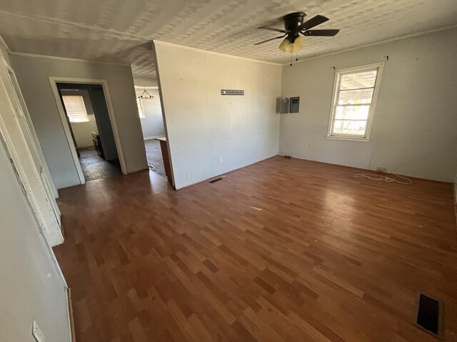 spare room with visible vents, ornamental molding, ceiling fan, and wood finished floors