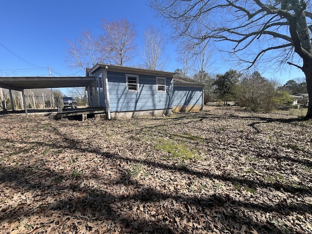 exterior space with crawl space and a carport