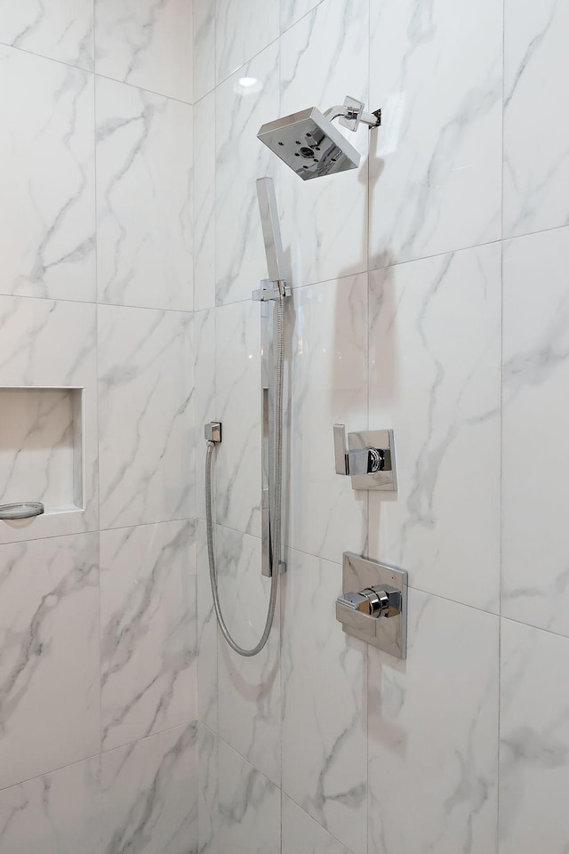 full bath with a marble finish shower