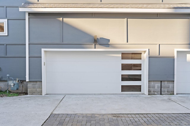 garage featuring concrete driveway