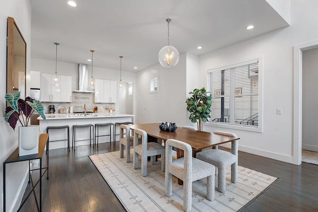 dining room featuring recessed lighting, dark wood-type flooring, and baseboards