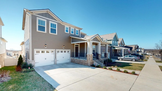 view of front of home featuring board and batten siding, a residential view, a garage, stone siding, and driveway