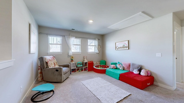 recreation room with visible vents, baseboards, carpet, and attic access