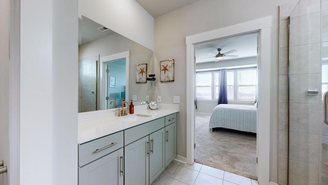 ensuite bathroom with tile patterned flooring, ceiling fan, a tile shower, ensuite bath, and vanity