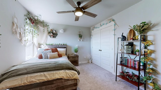 carpeted bedroom featuring a closet, baseboards, visible vents, and a ceiling fan