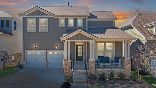 craftsman-style home featuring a porch, board and batten siding, driveway, and a shingled roof