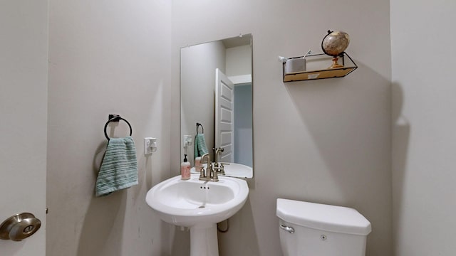 bathroom featuring toilet and a sink