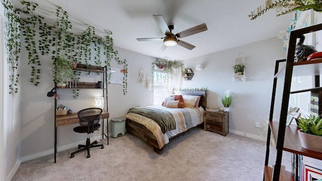 bedroom with light colored carpet, baseboards, and ceiling fan