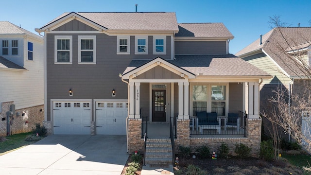 craftsman-style home with covered porch, board and batten siding, concrete driveway, and roof with shingles