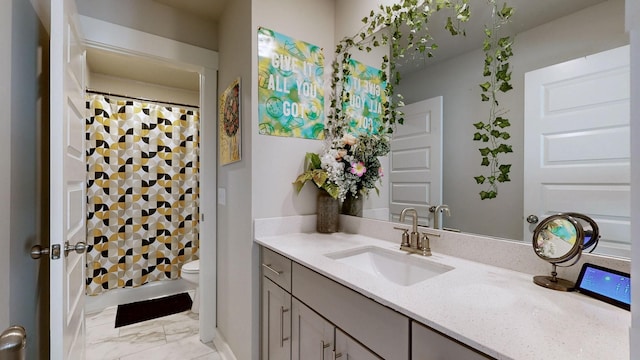 bathroom featuring marble finish floor, curtained shower, toilet, and vanity