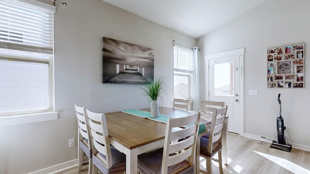 dining room featuring baseboards and light wood-type flooring