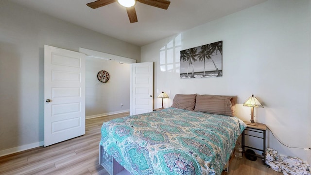 bedroom with baseboards, wood finished floors, and a ceiling fan