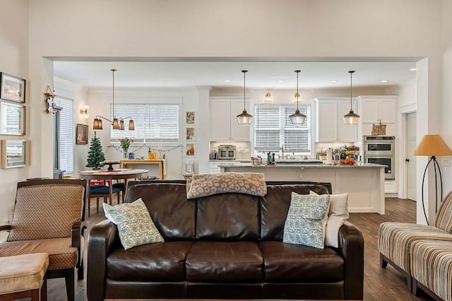 living room featuring recessed lighting and dark wood-style floors