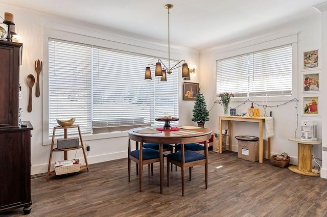 dining space featuring baseboards, plenty of natural light, and dark wood-style floors