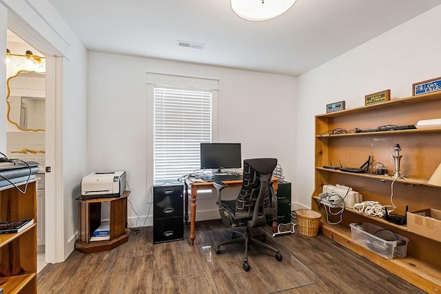 office area featuring visible vents, baseboards, and wood finished floors