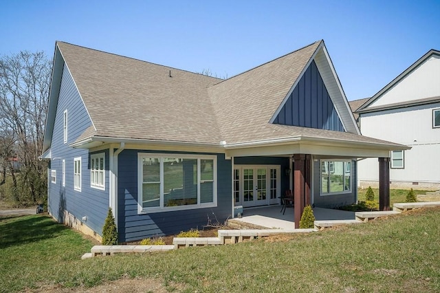 back of property with a patio area, french doors, a lawn, and a shingled roof