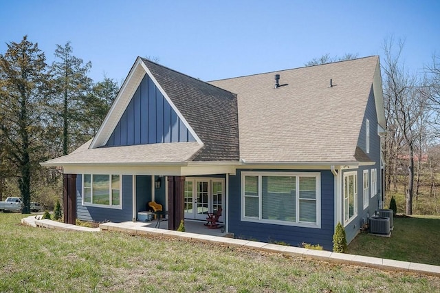 view of front of home featuring french doors, a patio, roof with shingles, and a front yard