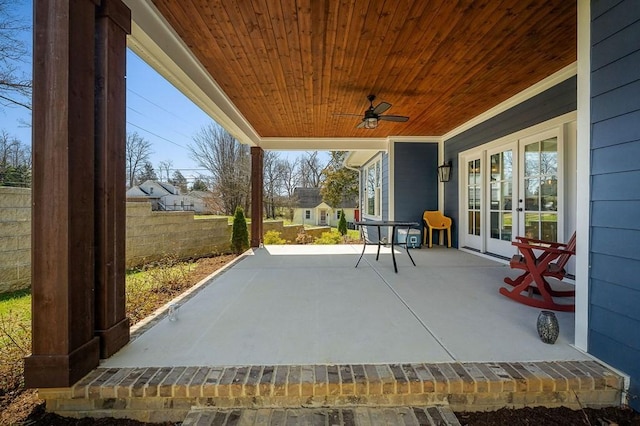 view of patio featuring french doors, fence, and ceiling fan