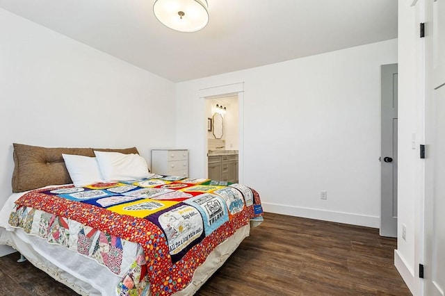 bedroom featuring dark wood-style floors, connected bathroom, and baseboards