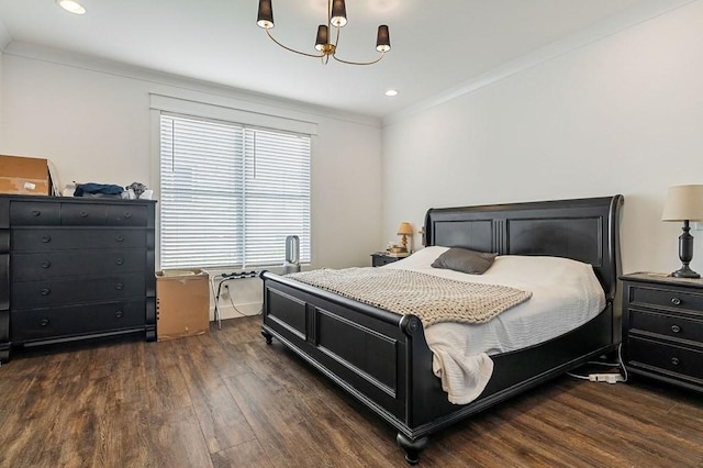 bedroom with dark wood finished floors, recessed lighting, an inviting chandelier, and ornamental molding