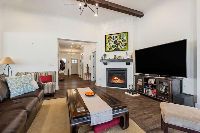 living area featuring crown molding, a notable chandelier, wood finished floors, and beam ceiling