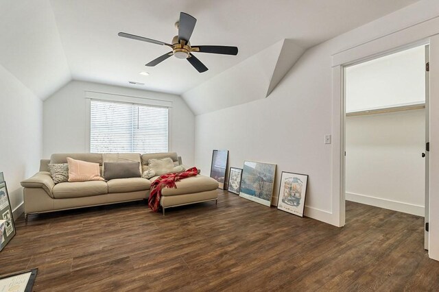 living area with vaulted ceiling, baseboards, and dark wood-style flooring