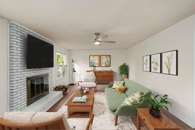 living room featuring ceiling fan, a fireplace, baseboards, and wood finished floors