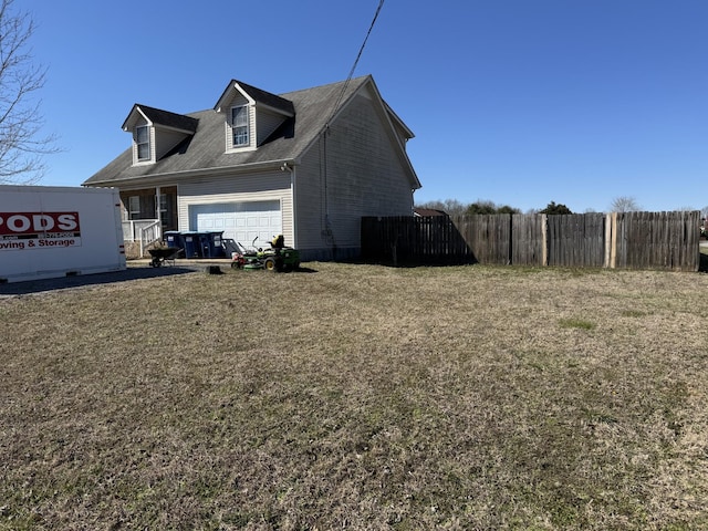 view of property exterior featuring a garage and fence