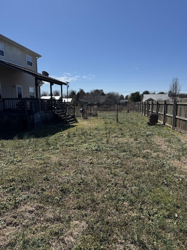 view of yard with a wooden deck and fence