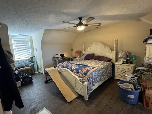 bedroom featuring a ceiling fan, lofted ceiling, wood finished floors, and a textured ceiling