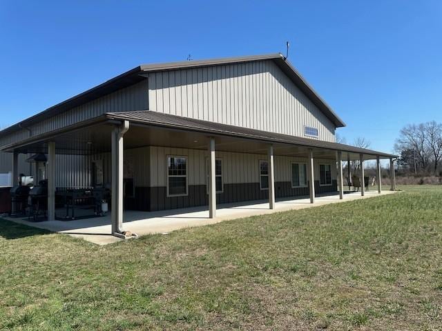 rear view of property with a patio area and a lawn