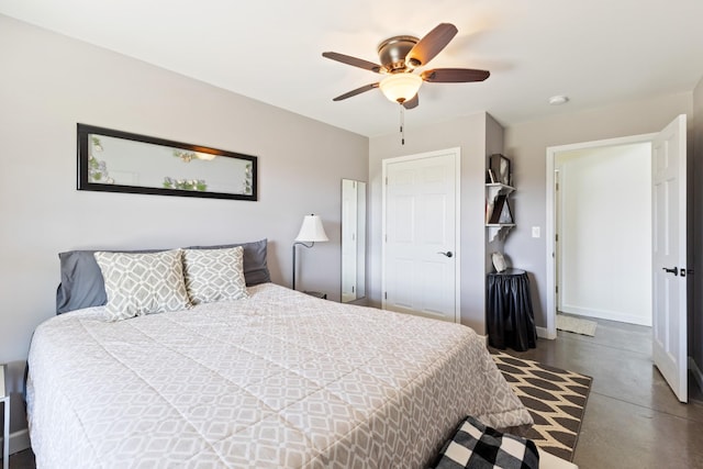 bedroom with finished concrete floors, a ceiling fan, and baseboards