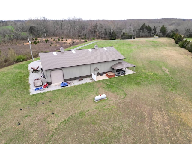 drone / aerial view featuring a view of trees