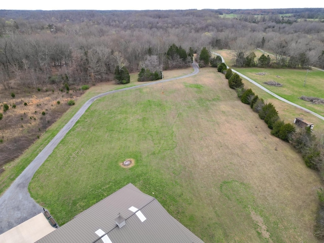 aerial view featuring a view of trees and a rural view