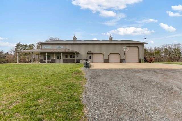 view of front of home with a front lawn, a garage, driveway, and a chimney
