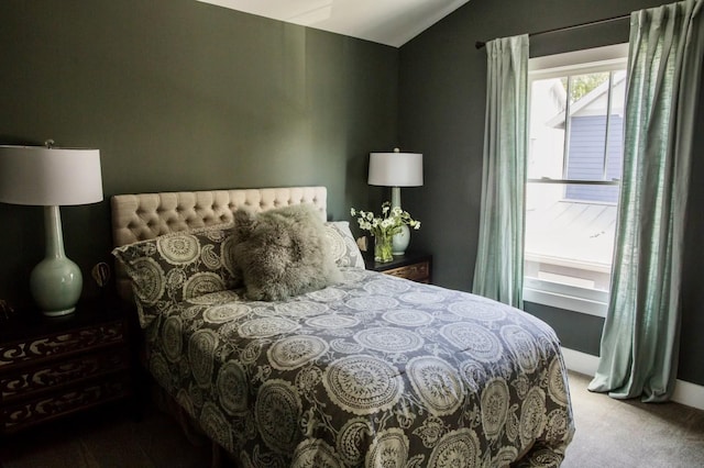 carpeted bedroom featuring vaulted ceiling